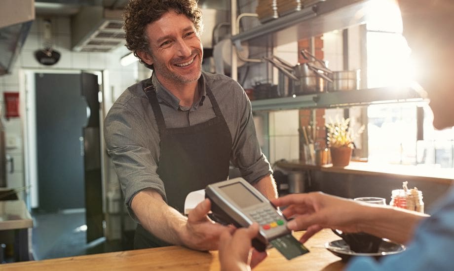 merchant cash advance - business owner accepting payment with card terminal