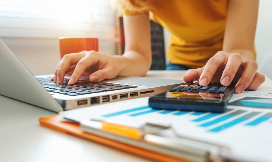 seven ways to raise 100k - busineess owner works on finances