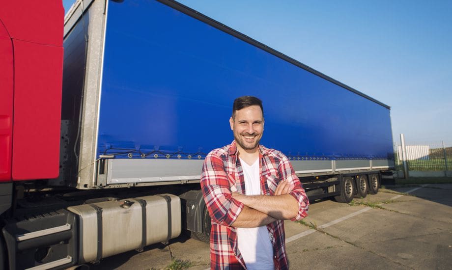 transport industry finance - business owner standing infront of a lorry